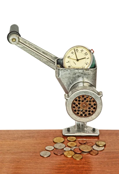 Alarm clock in manual meat grinder and coins on wooden table. — Stock Photo, Image