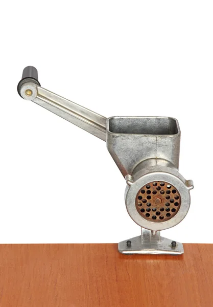 Manual meat grinder on wooden table and white background. — Stock Photo, Image