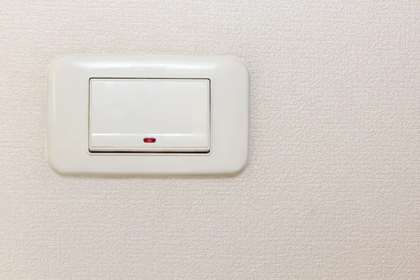 Light switch on beige wall. — Stock Photo, Image