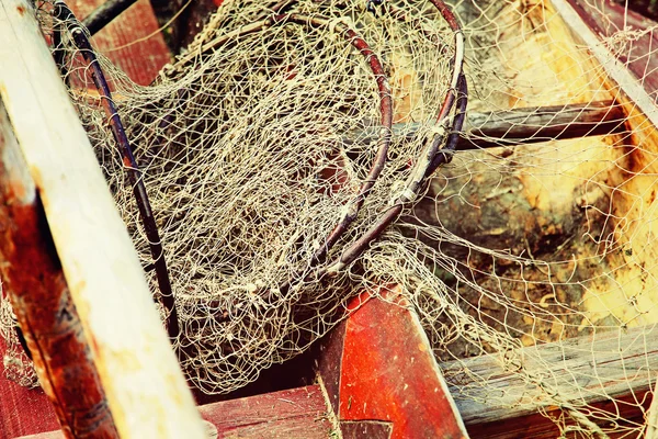 Fishing tackles in old wooden boat taken closeup. — Stock Photo, Image