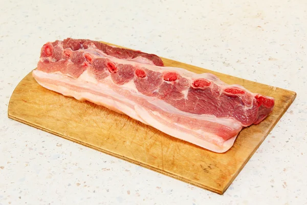 Raw pork ribs on wooden cutting board. — Stock Photo, Image