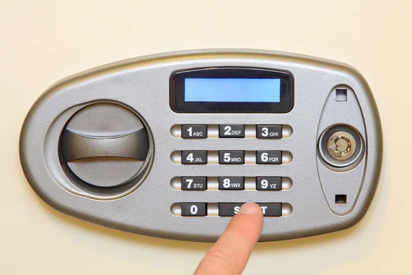 Man finger press start button on electronic home safe. — Stock Photo, Image