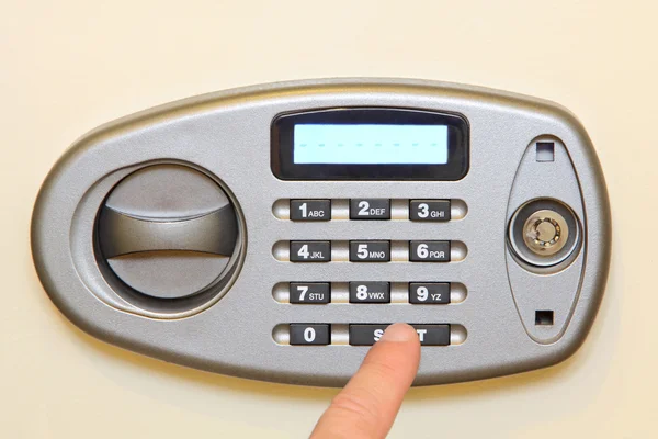 Man finger press start button on electronic home safe. — Stock Photo, Image