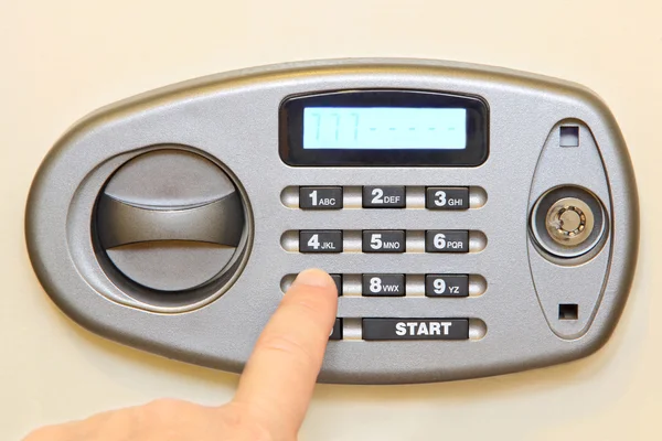 Man finger press button on electronic home safe. — Stock Photo, Image