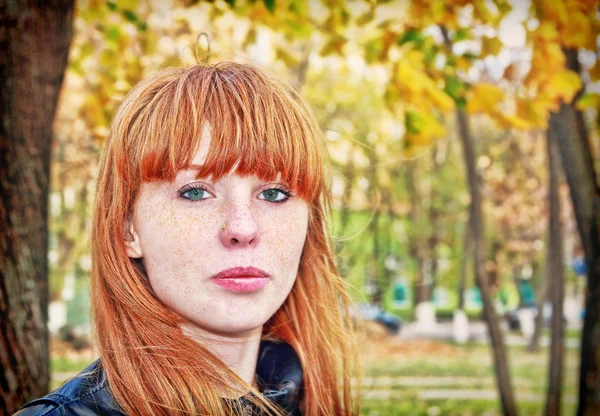 Pretty red hair girl looks at camera. — Stock Photo, Image