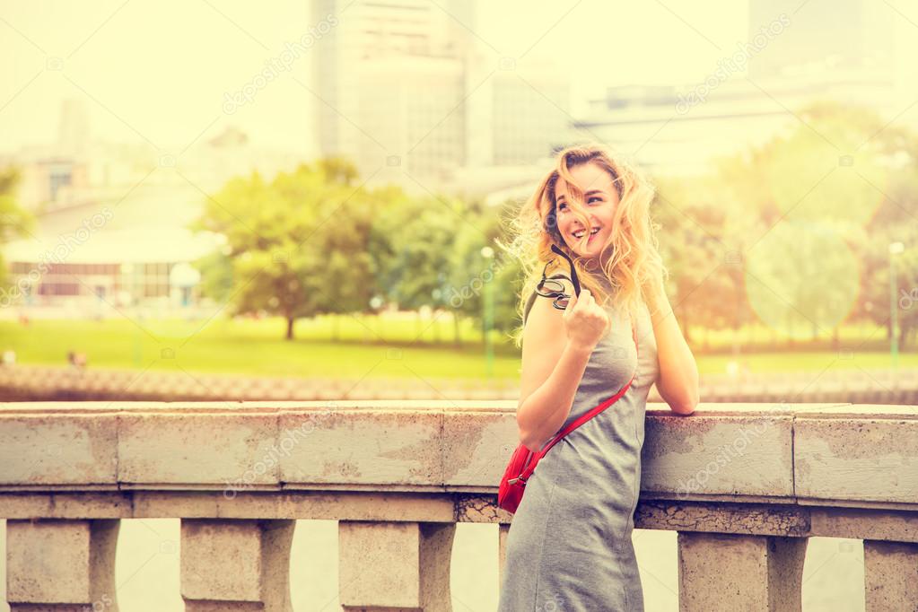 Young beautiful woman walking in old city street arcade summer europe vacation travel fun happy smiling stock photo