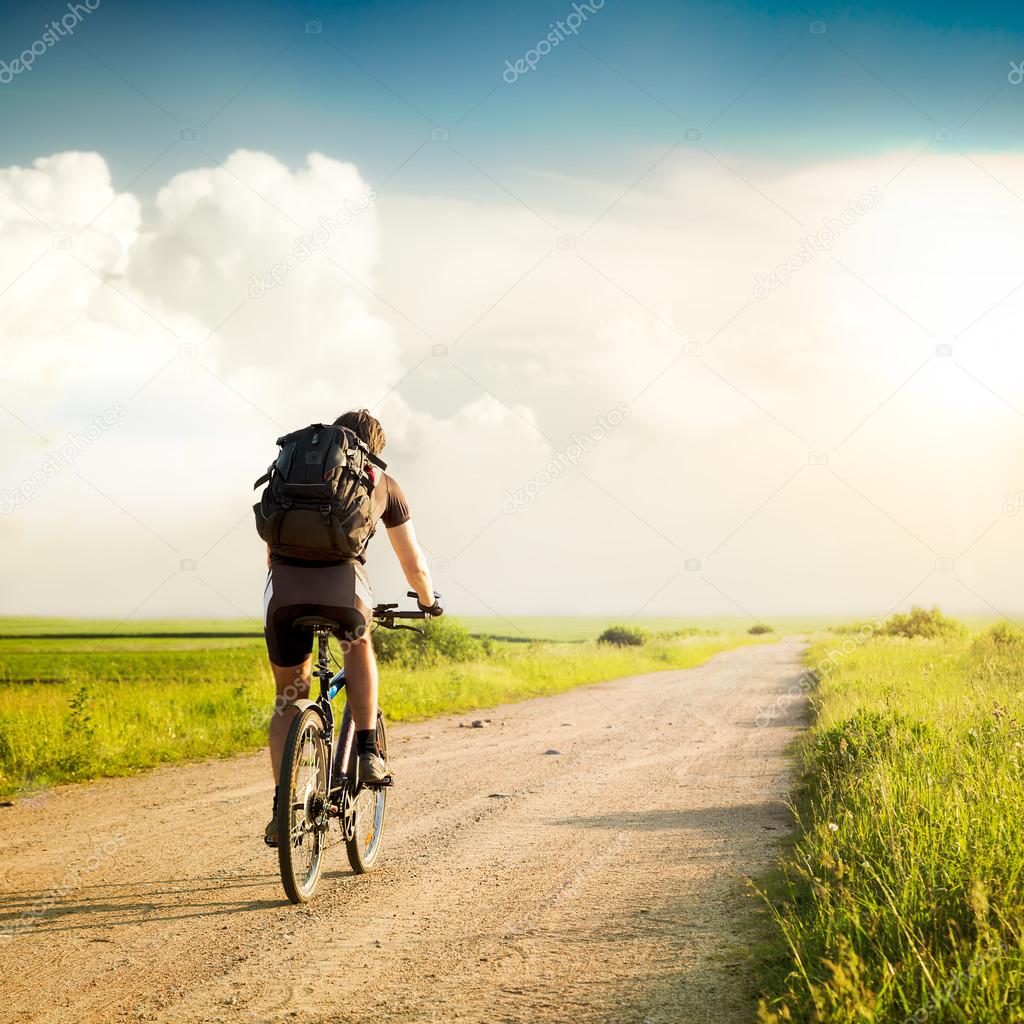 Man with Backpack Riding a Bicycle