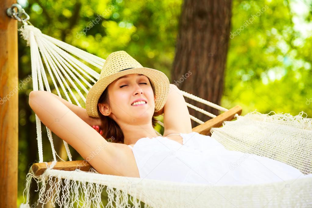 Happy Woman Relaxing in a Hammock