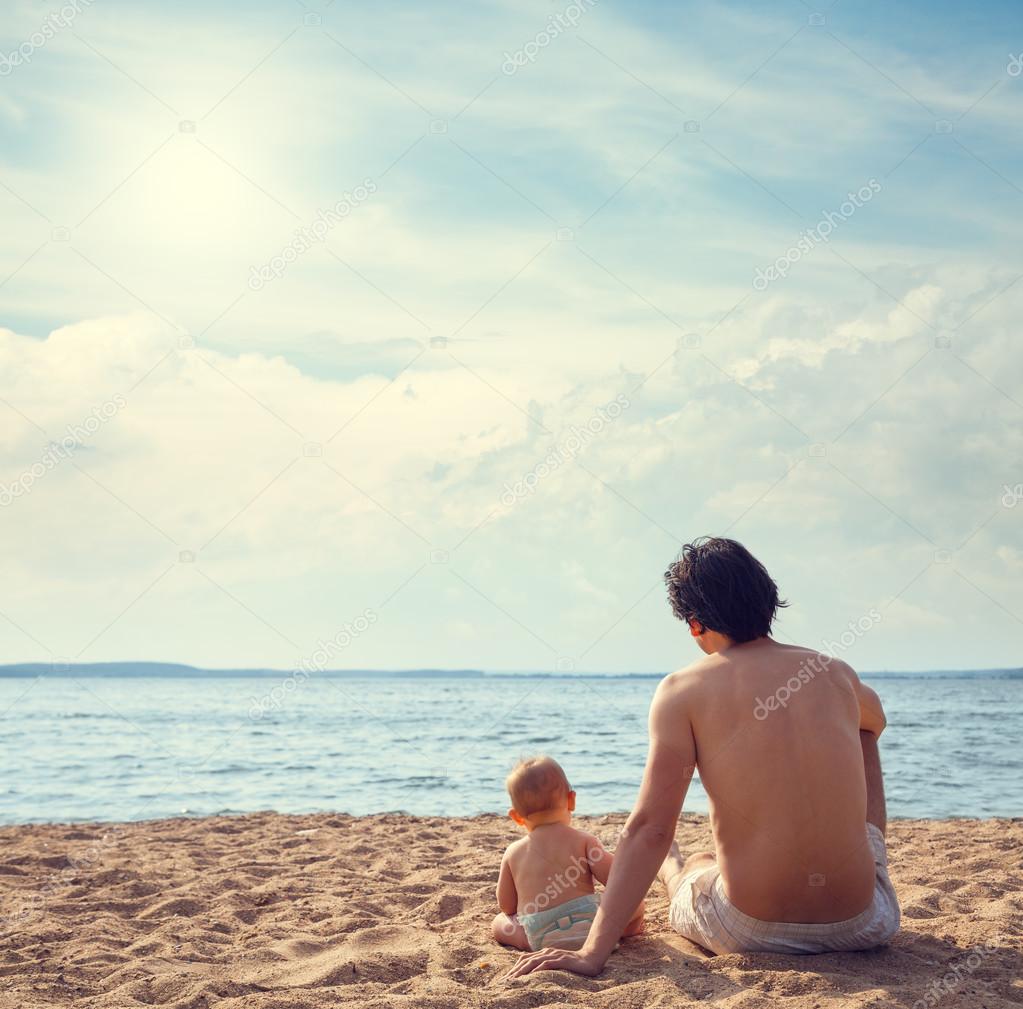 Young Father with His Son on the Beach
