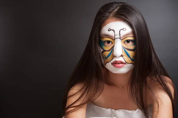 Girl with butterfly painted on face — Stock Photo, Image