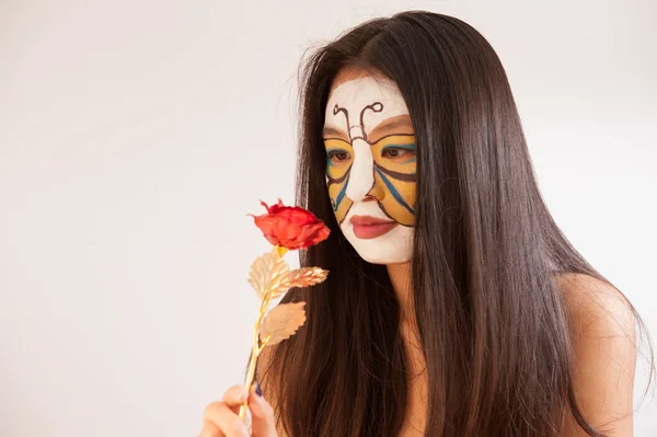 Girl with butterfly painted on face — Stock Photo, Image