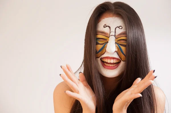 Girl with butterfly painted on face — Stock Photo, Image