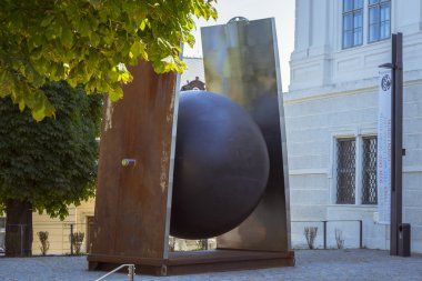 Modern industrial sculpture - a metal ball about Jezujit kolej