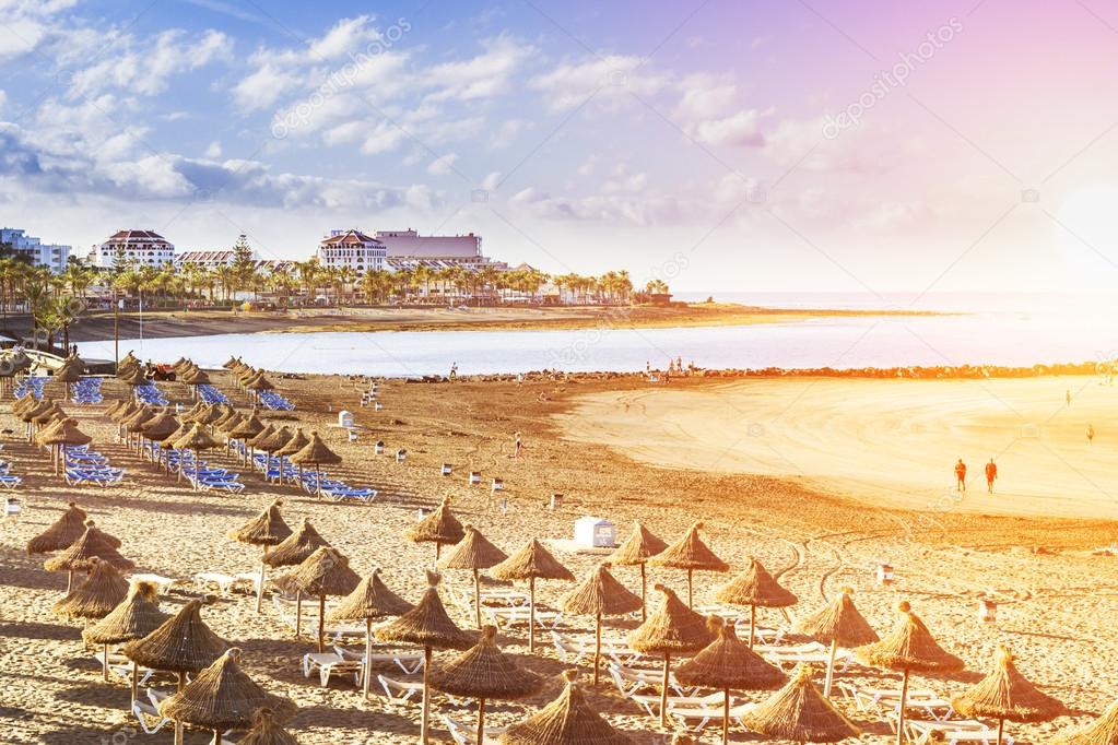 Straw umbrellas and loungers on the Playa de Las Americas, Tener