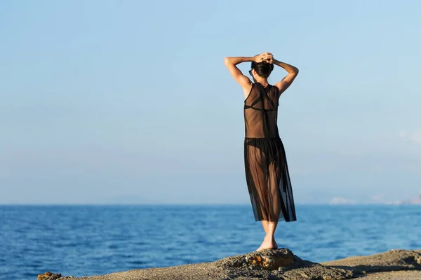 Young slim gitl looking to the ocean Stock Image