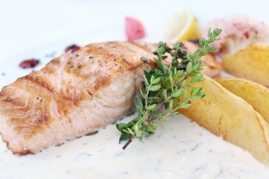 Patates dilimleri ve kekik ile pişmiş somon