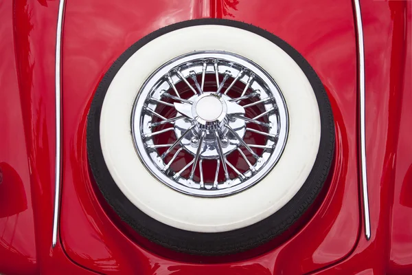 White tire on red car trunk — Stock Photo, Image