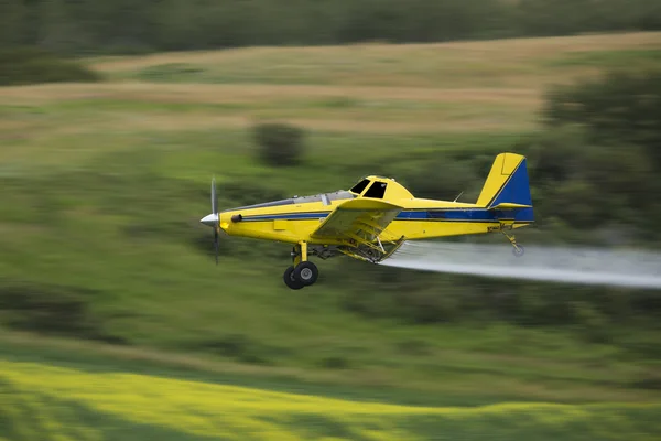 Crop duster Spraying a field Royalty Free Stock Images
