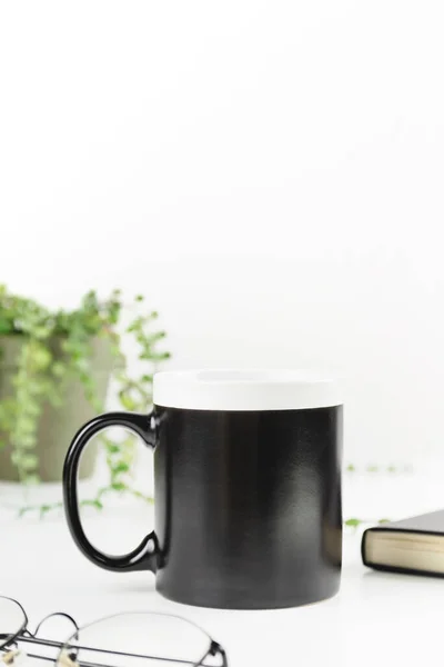 Black dad coffee mug mockup on workplace. Cup mock up for male style design