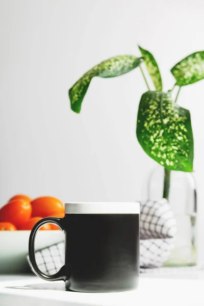 Mockup tazza da caffè nero sul tavolo della cucina. Coppa mock up per il design — Foto Stock