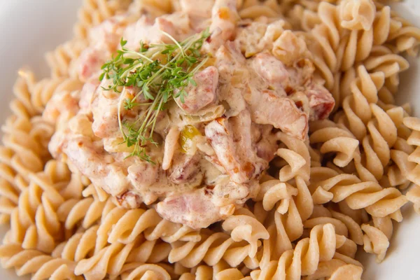 Düdük makarna krema ve domuz pastırması sos ile tere ile dekore edilmiştir.