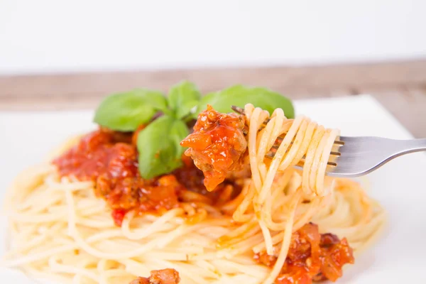 Espaguetis boloñeses comidos con un tenedor —  Fotos de Stock