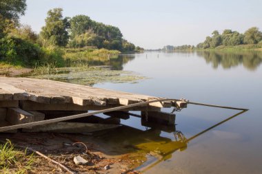 Feribot yanaşma istasyonu olan bir nehir. 