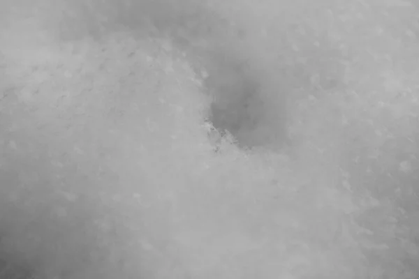 Snow surface in close up. Fresh white snow texture. Winter background.