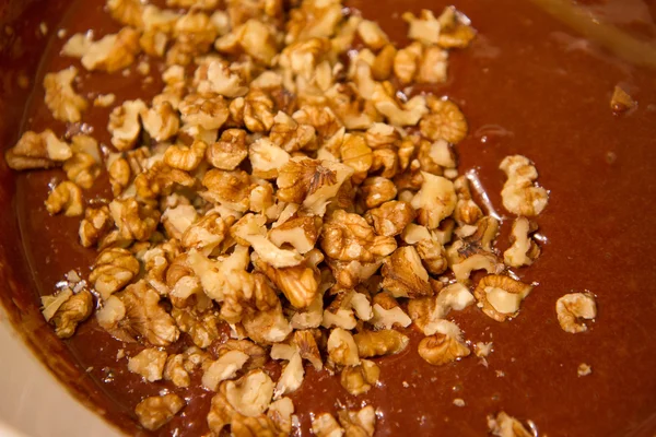 Baking Brownie Adding Chopped Nuts Stock Image