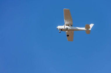 A private plane flying isolated on blue sky