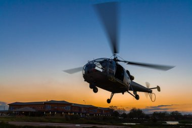 Helicopter at sunset clipart