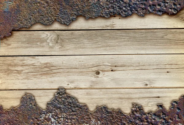 Wooden board among rusty metal — Stock Photo, Image