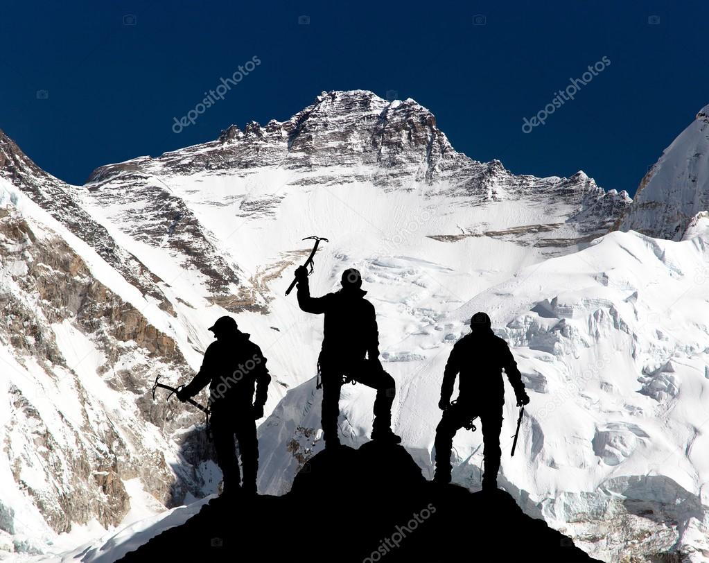 mount Lhotse and silhouette of group of climbers