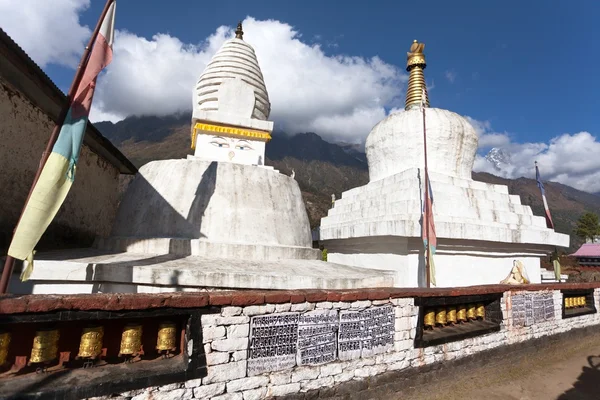 Stupa with prayer flags and wheels — ストック写真