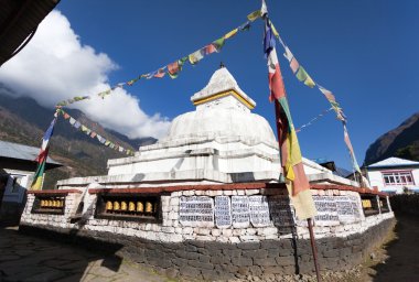 Stupa with prayer flags and wheels