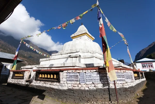 Stupa with prayer flags and wheels — Stock Photo, Image