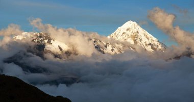 Evening view of Mount Salkantay or Salcantay in the middle of clouds, view from Choquequirao trekking trail, Cuzco or Cusco area, Machu Picchu area, Peruvian Andes clipart