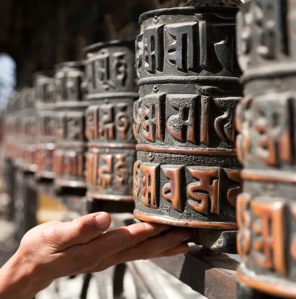 Prayer wheels and a hand — Stock Photo, Image