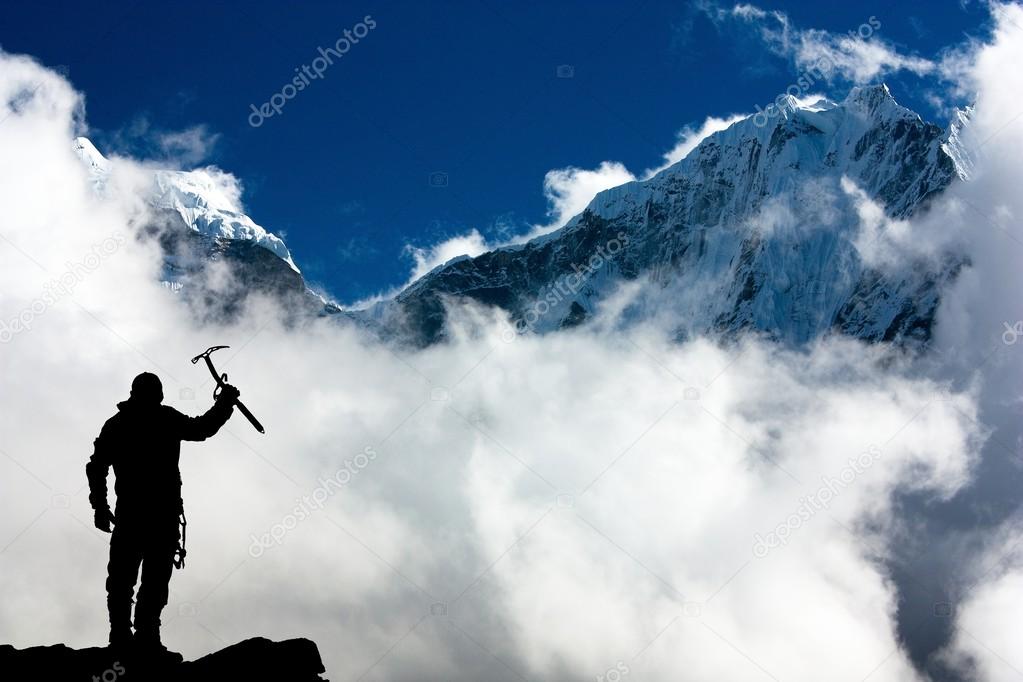 Silhouette of man with ice axe in hand