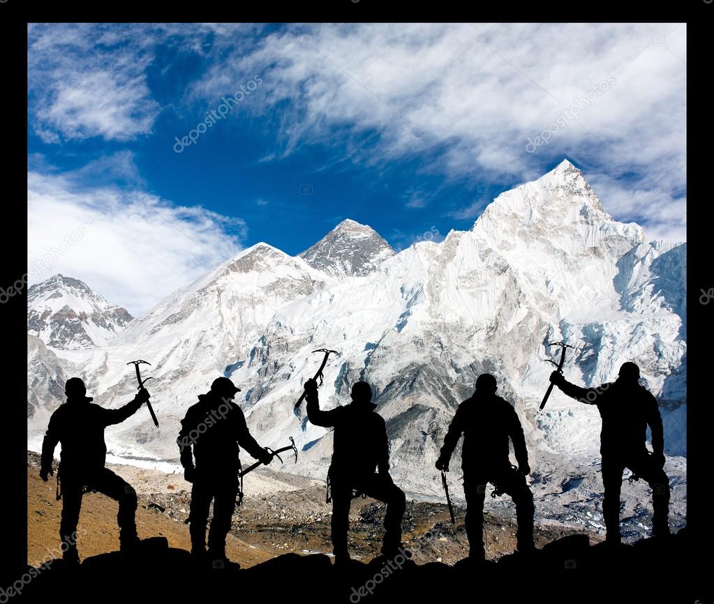 Mount Everest and silhouette of climbing men