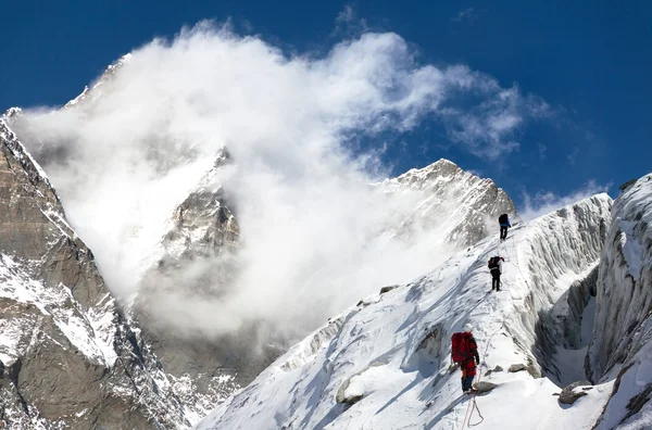 Group of climbers on mountains montage to mount Lhotse — Stock Photo, Image