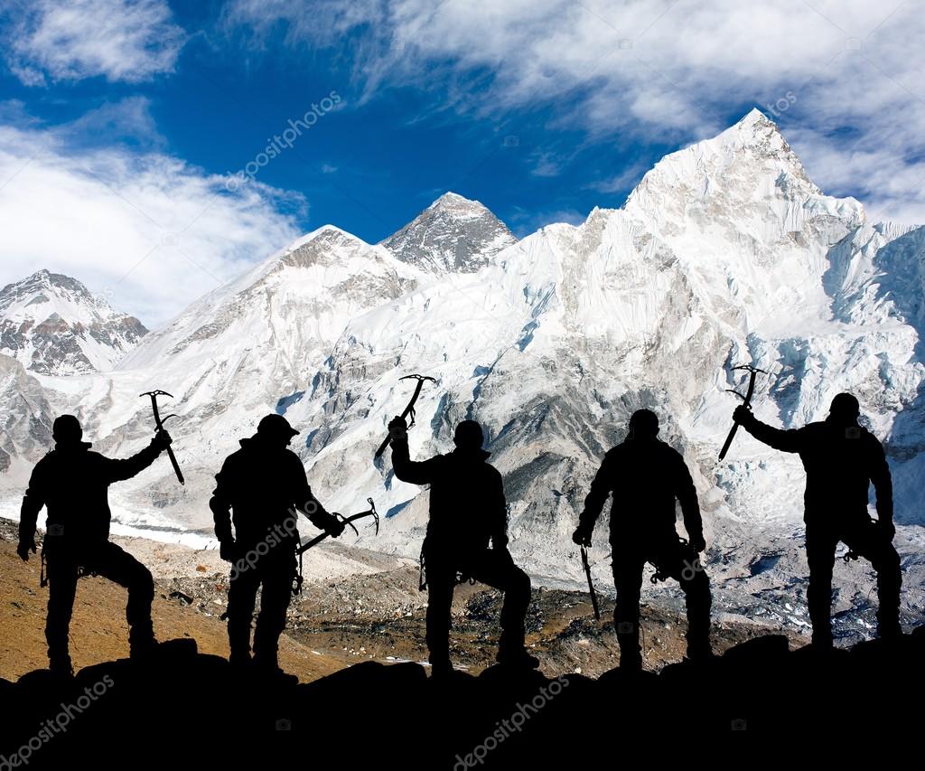 Mount Everest and silhouette of climbing men