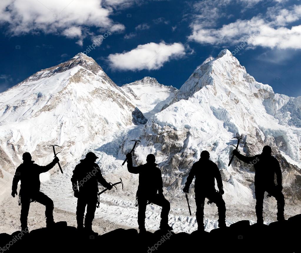 Silhouette of men with ice axe in hand, Mount Everest