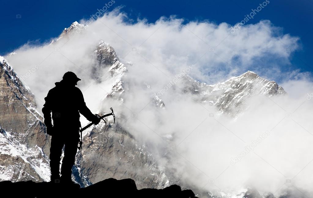 Mount Lhotse and silhouette of man wirh ice axe