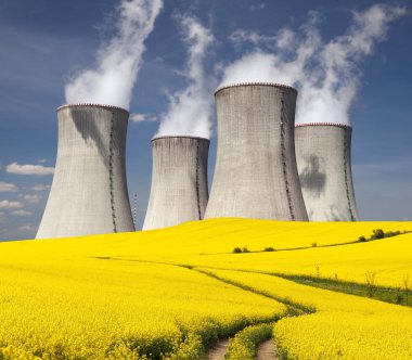 Nuclear power plant Dukovany with golden flowering field clipart