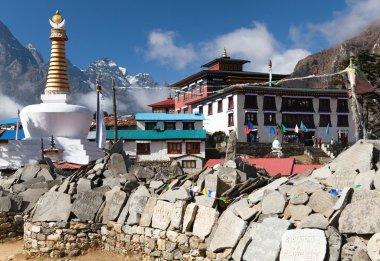 Tengboche monastery with stupa and prayer mani wall clipart