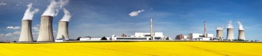 Nuclear power plant Dukovany with golden glowering field clipart