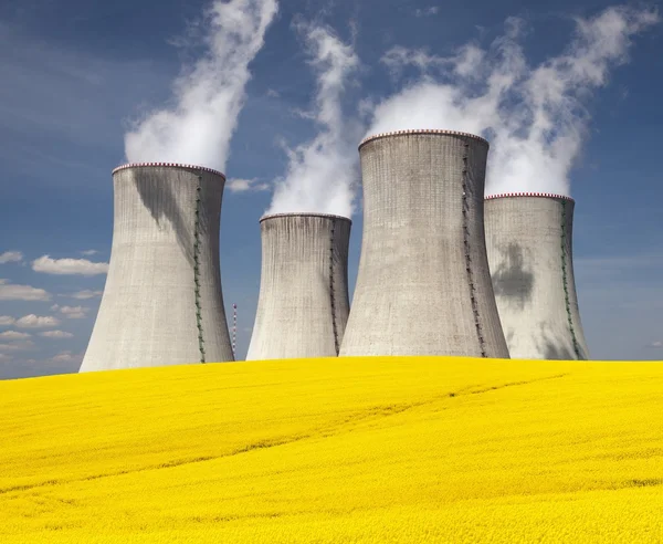 Cooling tower and rapeseed field — Stock Photo, Image