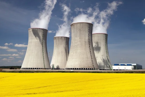 Cooling tower and rapeseed field — Stock Photo, Image