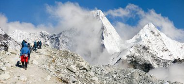 Buzullardaki yürüyüşçüler ya da turistler arka plandaki Himalayalar 'ı kaplamış, Everest ana kampı yürüyüş yolu, Nepal Himalaya dağı.